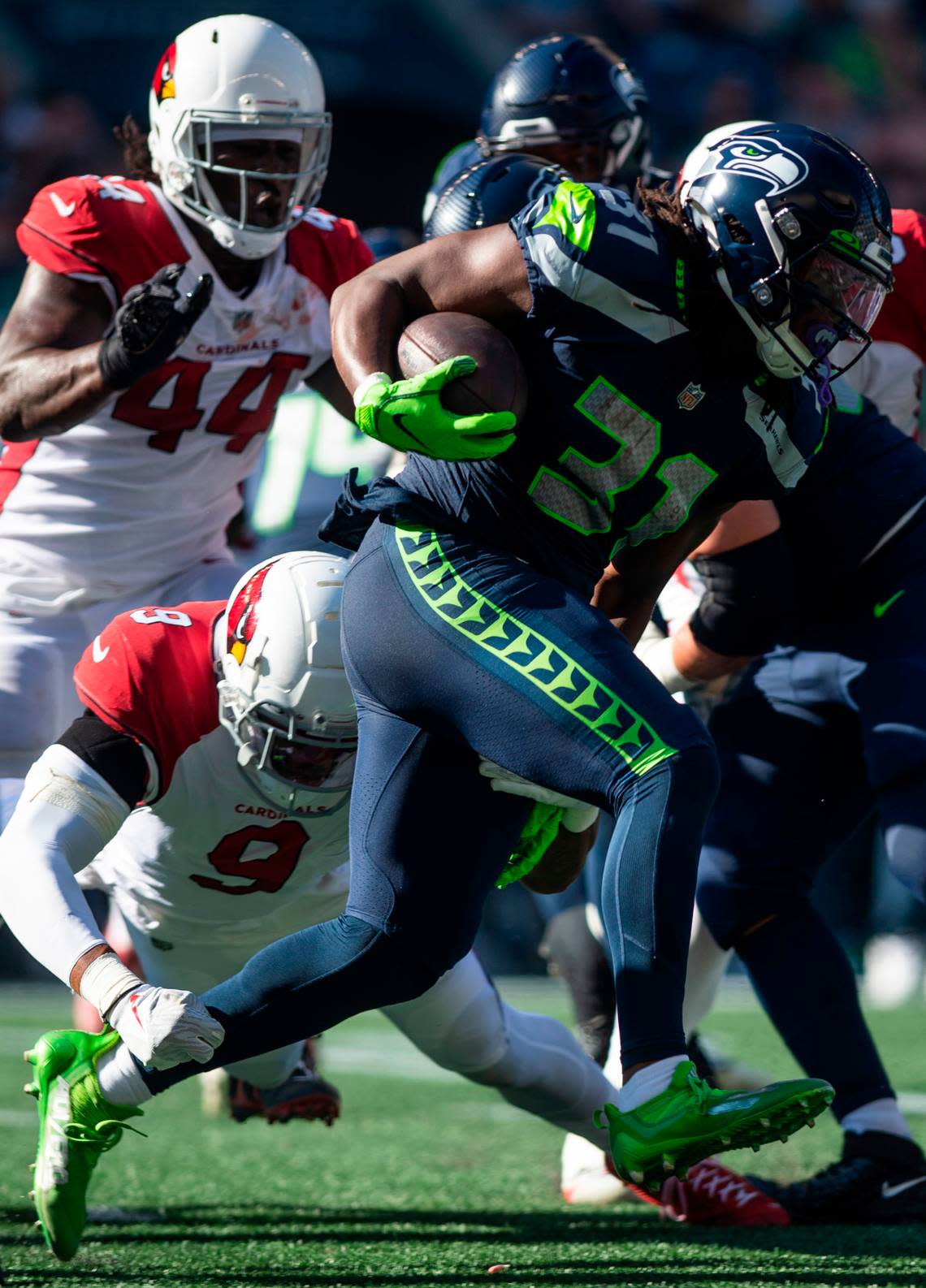 Seattle Seahawks running back DeeJay Dallas (31) runs down the field with the ball after Seattle Seahawks quarterback Geno Smith (7) handed it off to him in the second quarter of an NFL game on Sunday, Oct. 16, 2022, at Lumen Field in Seattle.