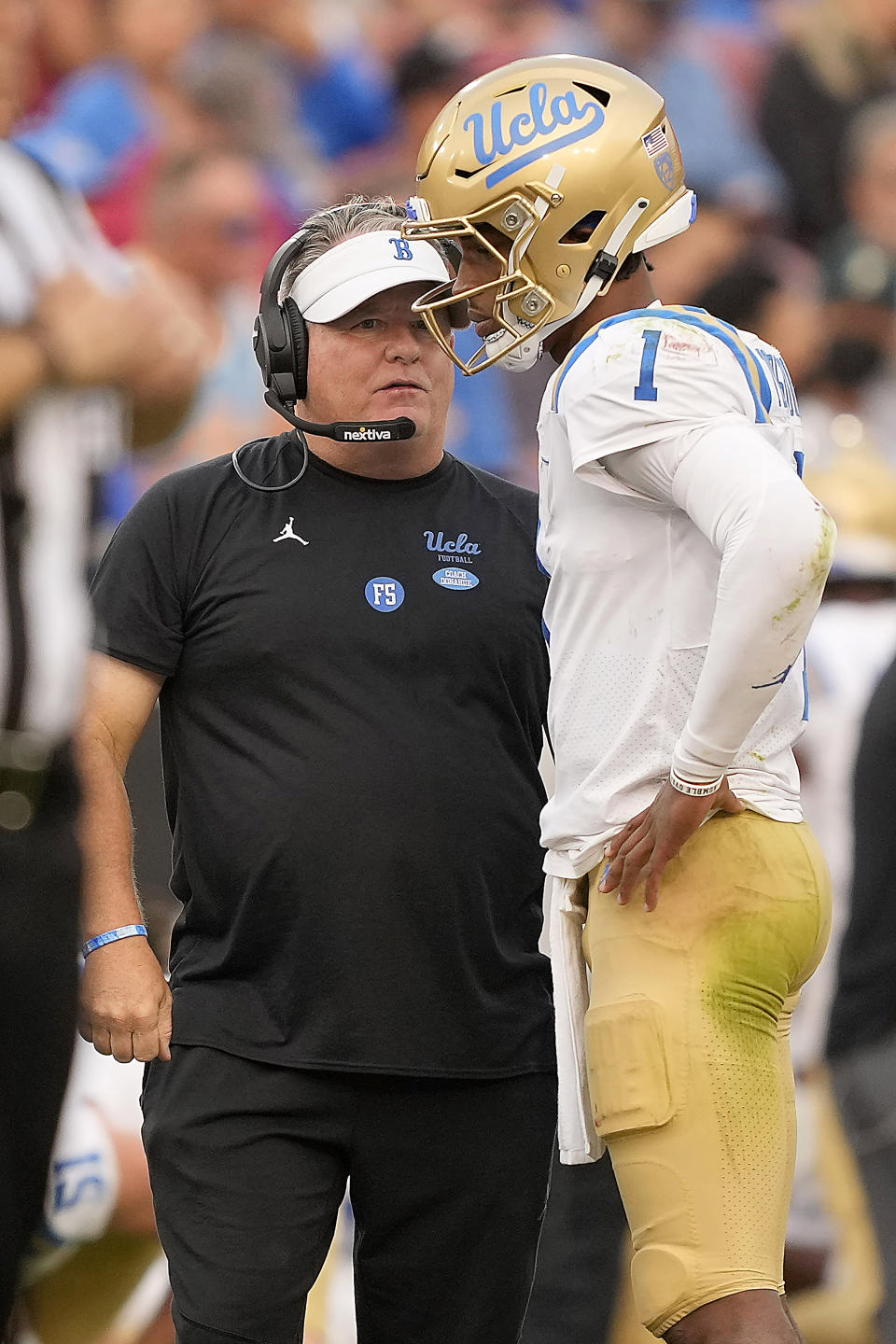 UCLA quarterback Dorian Thompson-Robinson (1) talks with head coach Chip Kelly, left, during a time out against Stanford during the second half of an NCAA college football game Saturday, Sept. 25, 2021, in Stanford, Calif. (AP Photo/Tony Avelar)