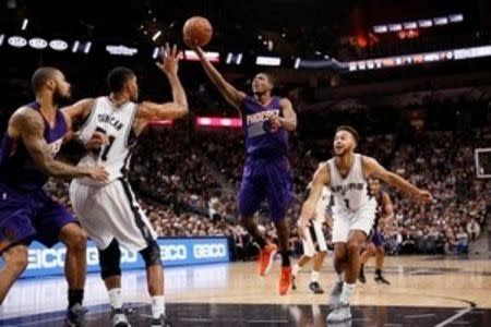 Phoenix Suns point guard Brandon Knight (3) puts up a shot over San Antonio Spurs power forward Tim Duncan (21) during the second half at AT&T Center. Mandatory Credit: Soobum Im-USA TODAY Sports