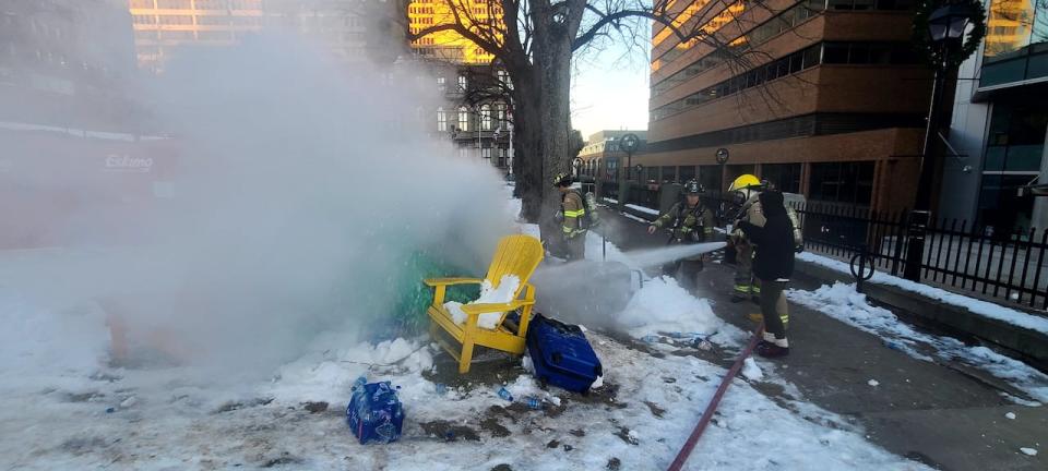 Firefighters extinguished a burning tent at the encampment outside Halifax's city hall Saturday morning.