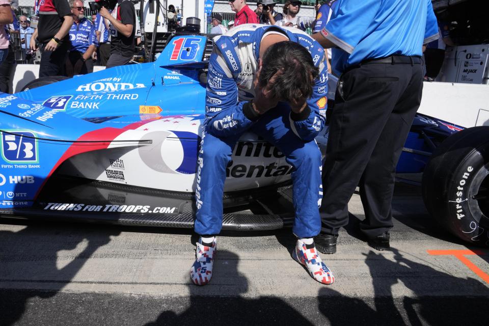 Graham Rahal sits on the side of his car after failing to make the field during qualifications for the Indianapolis 500 auto race at Indianapolis Motor Speedway in Indianapolis, Sunday, May 21, 2023. (AP Photo/Michael Conroy)