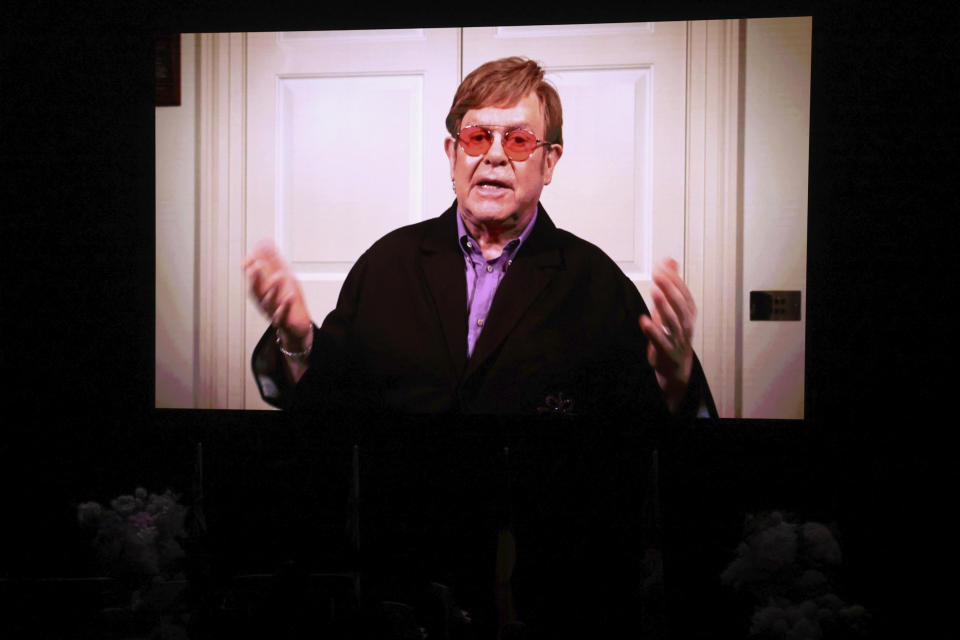 A video tribute from British entertainer Elton John is shown on a screen during the State Memorial Service for Australian comedian and actor Barry Humphries at the Sydney Opera House in Sydney, Friday, December 15, 2023. King Charles III has paid tribute to the late Barry Humphries at a state memorial service with a message that recalled the monarch's own apprehension when the comedian's alter ego Dame Edna Everage played a prank on him in a royal box a decade ago (David Gray/Pool Photo via AP)