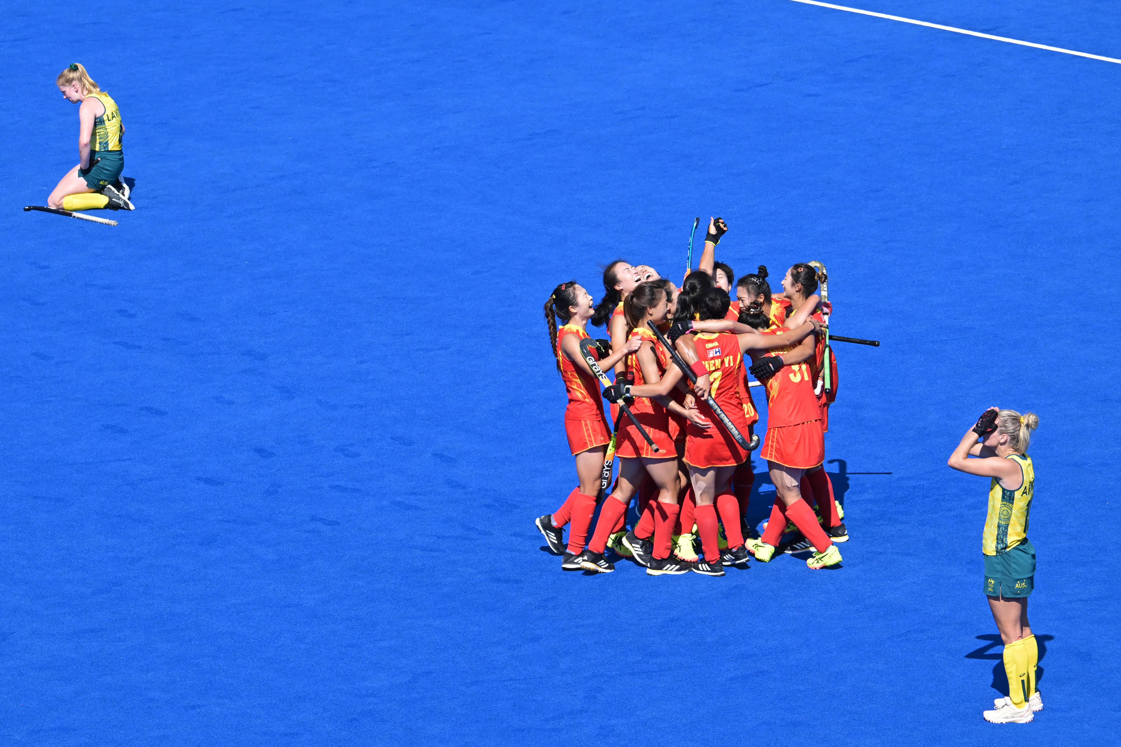 China's players celebrate winning the women's quarter-final field hockey match between Australia and China during the Paris 2024 Olympic Games at the Yves-du-Manoir Stadium in Colombes on August 5, 2024. (Photo by Damien MEYER / AFP)