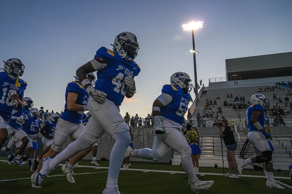 Pflugerville players take the field at, well, The Pfield ahead of Thursday night's win over Navarro. The Panthers improved to 4-0 on the season.