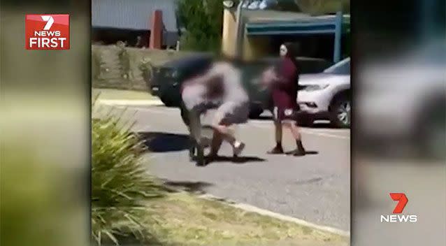 One girl launches at her opponent, grabbing her hair and flinging her to the ground. Source: 7 News