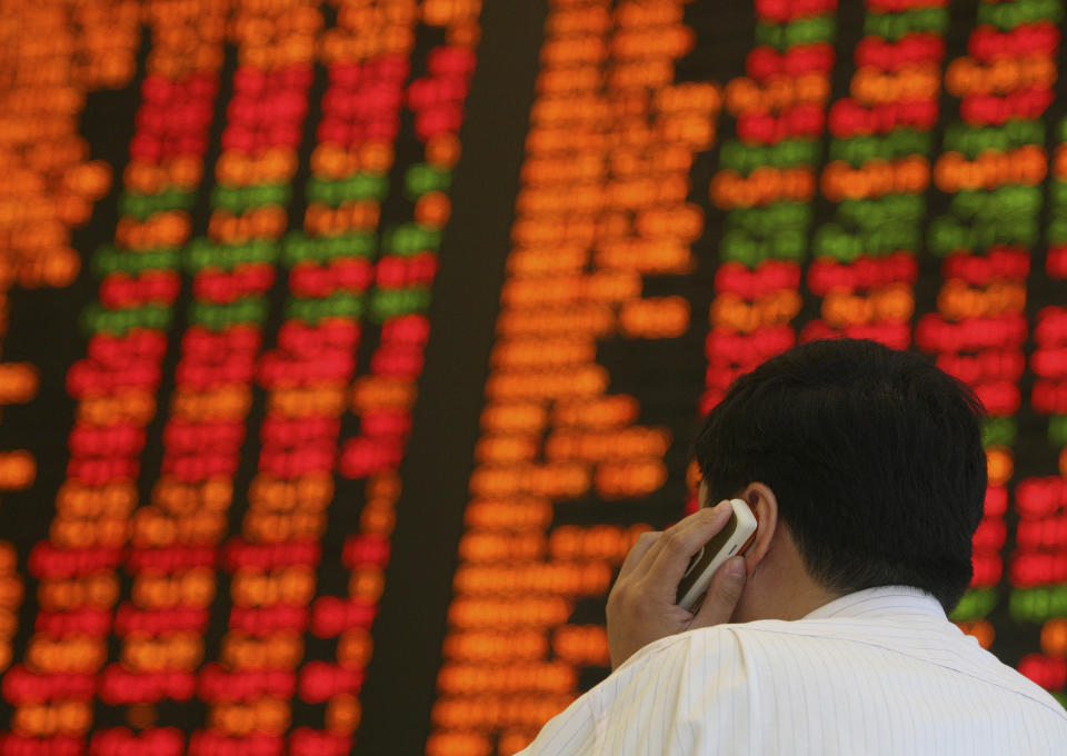 A visitor speaks on a mobile phone as he studies stock prices at the Australian Securities Exchange in Sydney, Australia, Monday, Jan. 21, 2008. The Australian stock market closed lower for the eleventh session in a row on Monday. At the close the S&P/ASX200 index was down 2.9 per cent to 5,580.4 with the All Ordinaries down 2.91 per cent to 5630.9. (AP Photo/John Pryke)