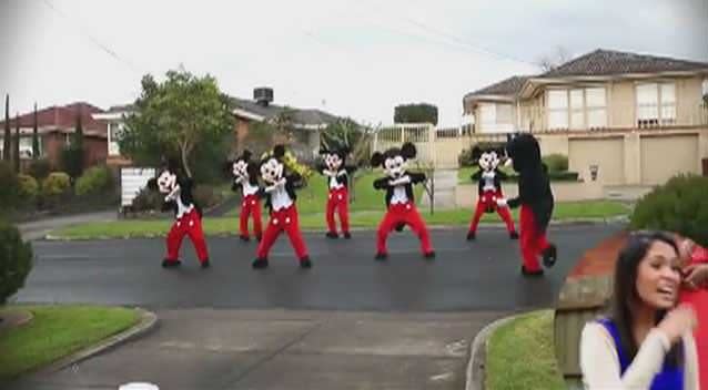 A stunned Vishanti giggles as a Mickey Mouse dance troupe groove in front of her Melbourne home. Photo: YouTube
