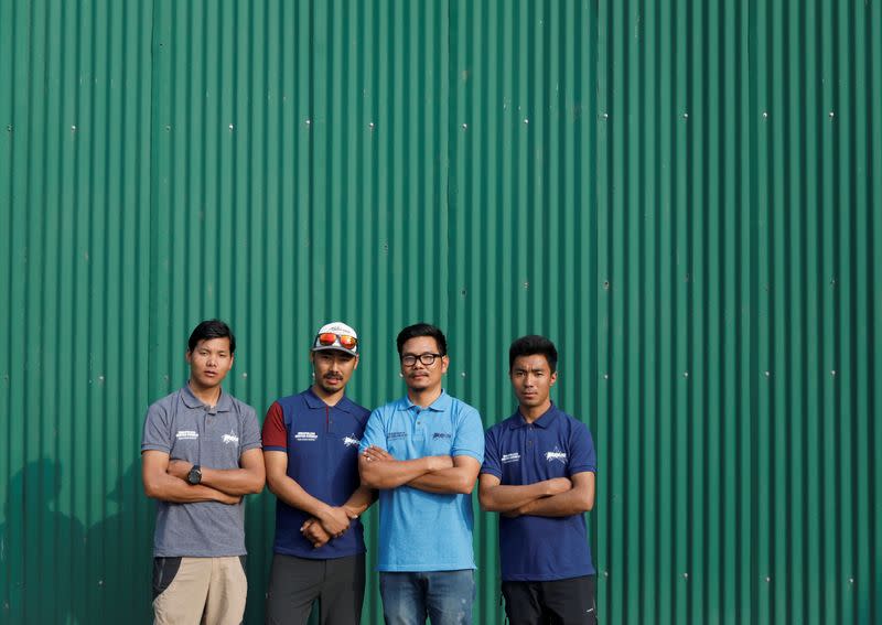 Ming Temba Sherpa, Halung Dorchi Sherpa, Tashi Lakpa Sherpa and Pasang Nurbu Sherpa pose for a group photo ahead of the news conference organised before heading to attempt the record for the winter Everest expedition in 5 days, in Kathmandu