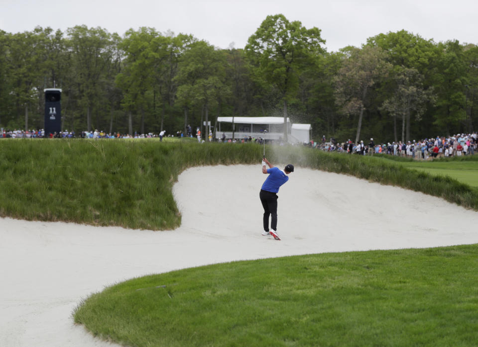 Brooks Koepka hits out of a bunker on the 11th hole during the final round of the PGA Championship golf tournament, Sunday, May 19, 2019, at Bethpage Black in Farmingdale, N.Y. (AP Photo/Julio Cortez)