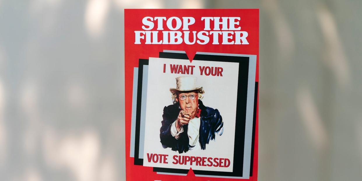 Virginia Shadron, of Atlanta, holds an anti-filibuster sign with the face of Senate Minority Leader Mitch McConnell of R-Ky., on it, during a rally in support of voting rights, Tuesday, Sept. 14, 2021, on Capitol Hill in Washington.