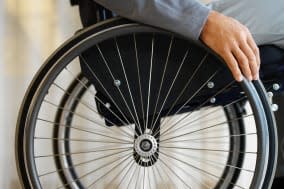 close up mid section view of a man sitting in a wheelchair