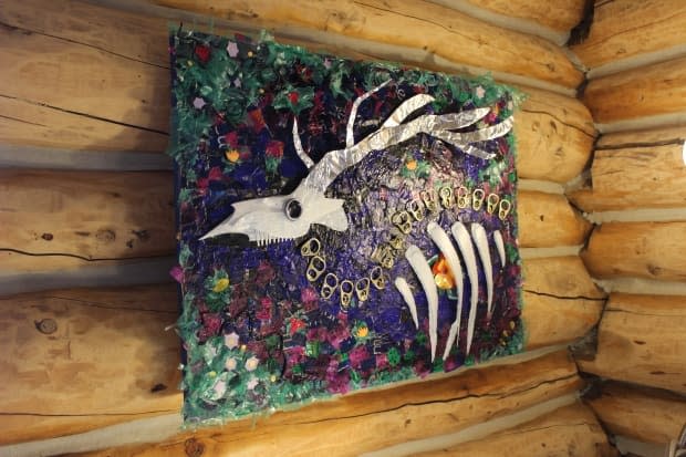 Wildlifeless by Emma Merlyn Butler hangs on one of the walls of the Wildcat Café in Yellowknife's Old Town neighbourhood. The space is being transformed into an artists centre until the end of September. (Liny Lamberink/CBC - image credit)