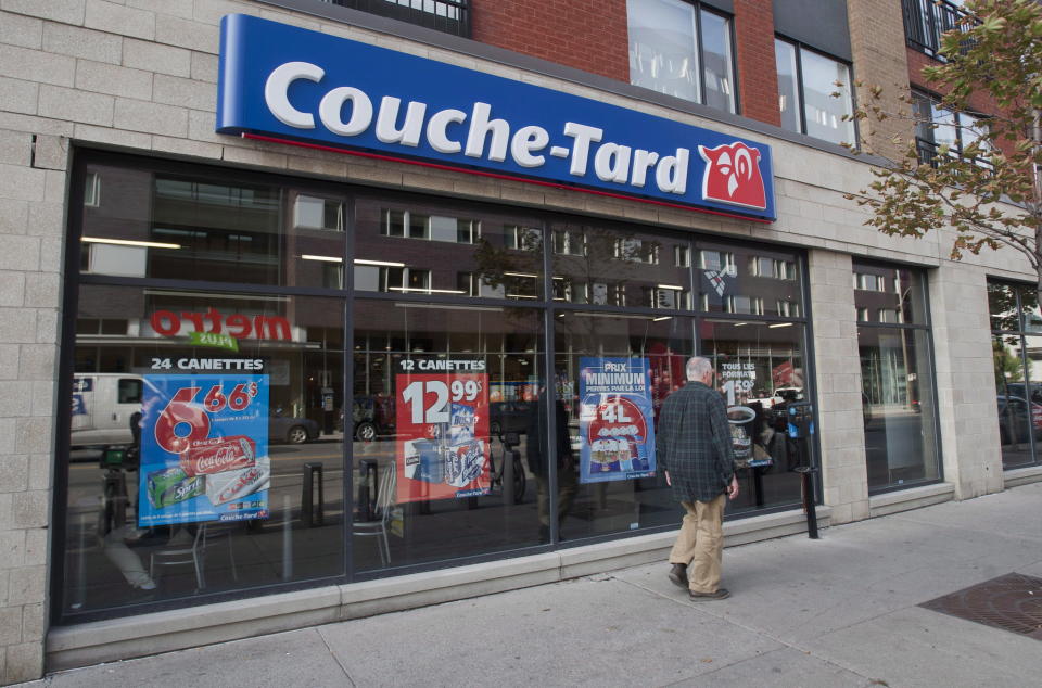 A man passes by a Couche Tard convenience store in Montreal, Friday, October 5, 2012. The chief executive of Alimentation Couche-Tard's (TSX:ATD.B) got into a nasty exchange over its anti-unionization stance at its annual meeting with shareholders. Alain Bouchard cut off a union leader and shareholder who sought an explanation about the company's fight against efforts to unionize its stores. THE CANADIAN PRESS/Graham Hughes.