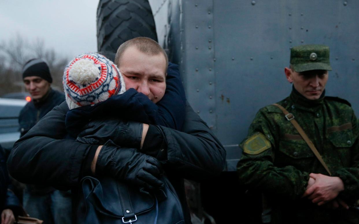 A prisoner of war from the Ukrainian armed forces is embraced during the exchange of captives in Horlivka in Donetsk region - REUTERS