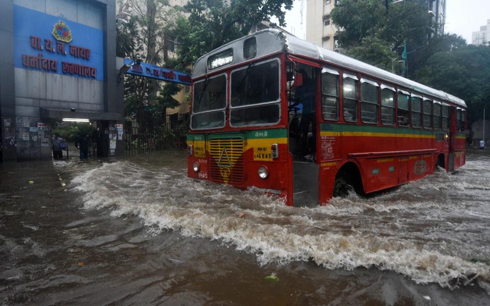 A bus drives through a waterlogged road during heavy rains in Mumbai - Anadolu Agency