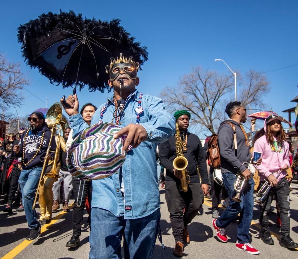 A band performs during the 2022 Marche du Nain Rouge, an annual parade in which costumed Detroiters chase away a folkloric demon with a grudge against the city.