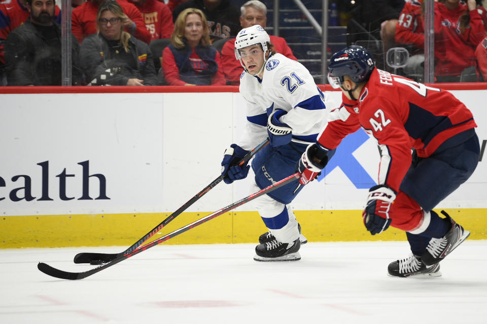 Tampa Bay Lightning center Brayden Point (21) skates with the puck against Washington Capitals defenseman Martin Fehervary (42) during the second period of an NHL hockey game, Saturday, Oct. 16, 2021, in Washington. (AP Photo/Nick Wass)