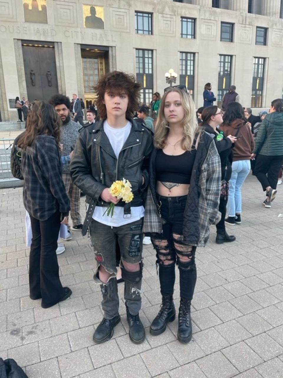 Willis Egan, 15, holds flowers that he brought to the vigil with his older sister, El, 23 – one flower for each victim killed on Monday, picked from their mother’s garden (Sheila Flynn)