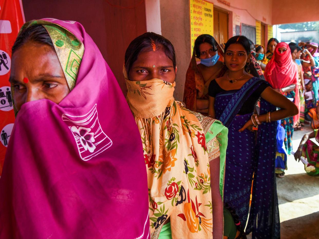 Voters queue up to cast their ballots for Bihar state assembly elections at a polling station (AFP via Getty Images)