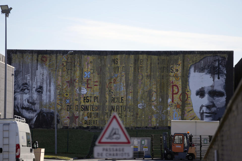 Portraits of scientists Albert Einstein and Marie Curie decorate a concrete-sealed warehouse for radioactive waste storage in Soulaines-Dhuys, eastern France, Friday, Oct. 29, 2021. The site holds low- to mid-level radioactive waste from French nuclear plants as well as research and medical facilities, and its concrete-sealed warehouses are designed to store the waste for at least 300 years. (AP Photo/Francois Mori)