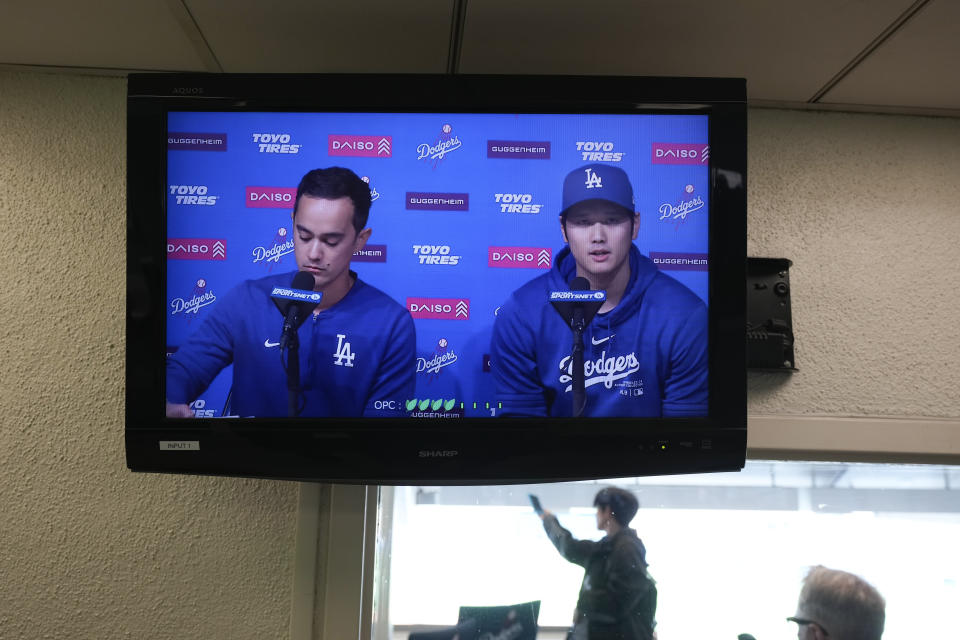 A video screen displays Los Angeles Dodgers' Shohei Ohtani, right, and interpreter Will Ireton during a news conference at Dodger Stadium in Los Angeles, Monday, March 25, 2024. (AP Photo/Jae C. Hong)