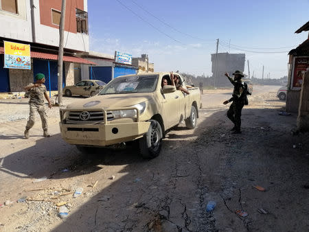 Troops from eastern Libyan forces are seen in Ain Zara, south of Tripoli, Libya April 11, 2019. REUTERS/Stringer