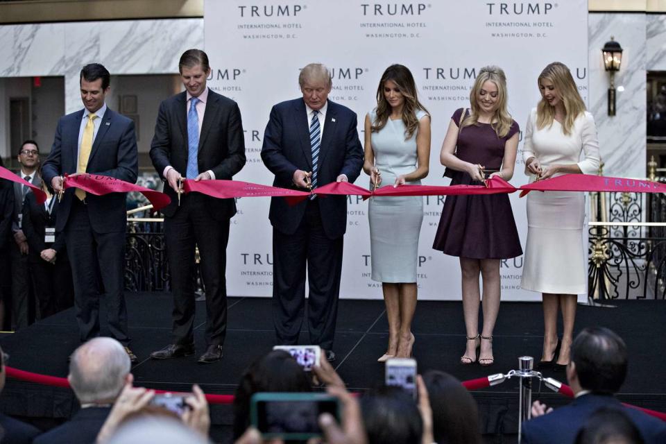 Donald Trump, 2016 Republican presidential nominee, center, cuts a ribbon with his sons Donald Trump Jr., from left, Eric Trump, his wife Melania Trump and his daughters Tiffany Trump and Ivanka Trump during the grand opening ceremony of the Trump International Hotel in Washington, D.C., U.S., on Wednesday, Oct. 26, 2016. The Trump Organization has eight hotels in the U.S. and seven in other countries. The Trump International Hotel Washington, D.C. is housed in the 1899 Romanesque Revival-style Old Post Office on Pennsylvania Avenue