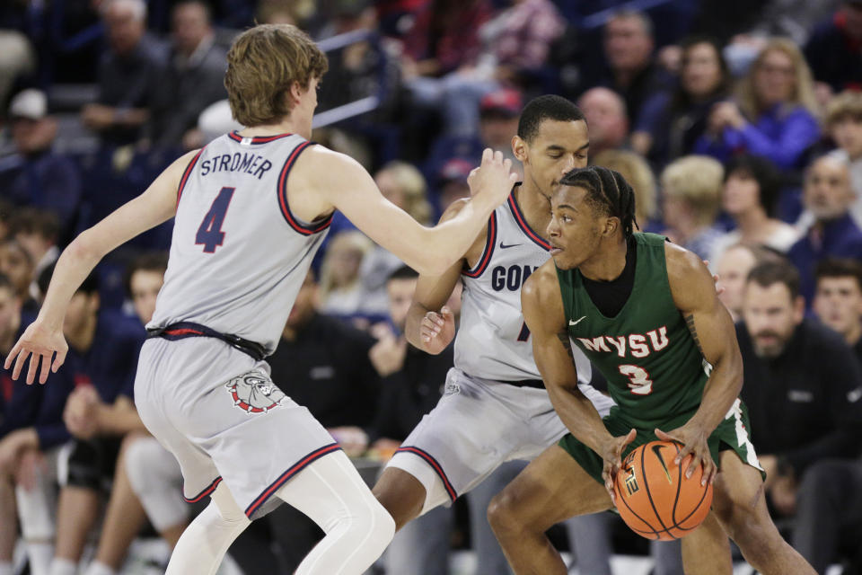 Gonzaga guards Dusty Stromer (4) and Nolan Hickman, center, double-team Mississippi Valley State guard Donovan Sanders (3) during the first half of an NCAA college basketball game, Monday, Dec. 11, 2023, in Spokane, Wash. (AP Photo/Young Kwak)