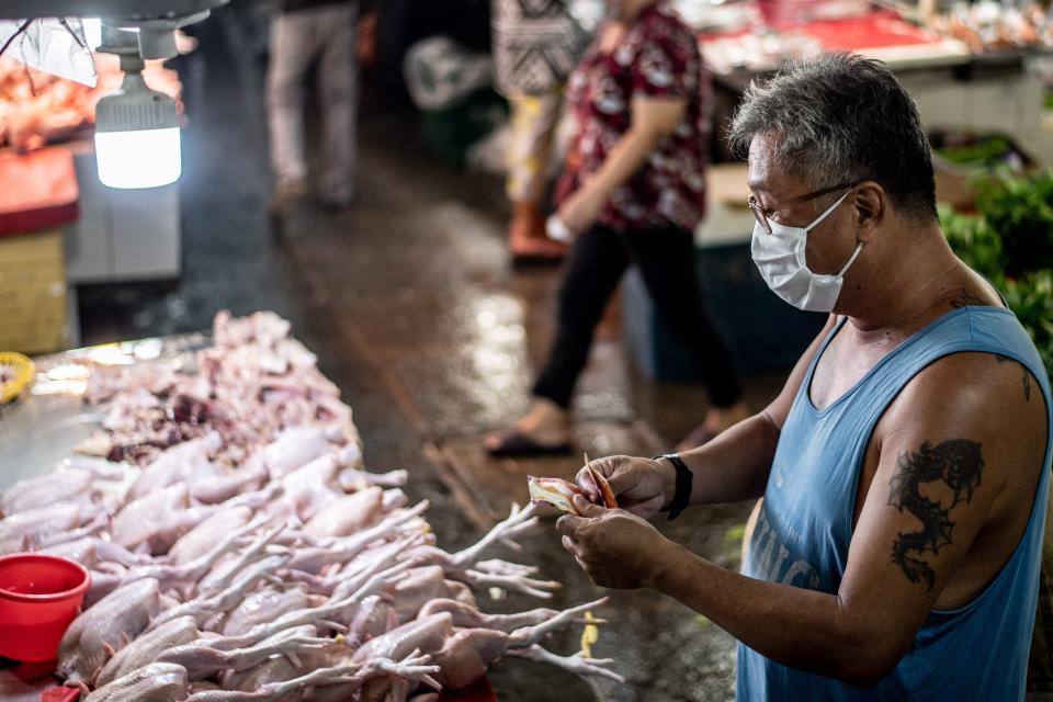 A vendor prepares chickens to sell at a market in Manila on August 6, 2020. - The Philippines plunged into recession after its biggest quarterly contraction in four decades, data showed on August 6, as the economy reels from COVID-19 coronavirus lockdowns that have wrecked businesses and thrown millions out of work. (Photo: LISA MARIE DAVID/AFP via Getty Images)