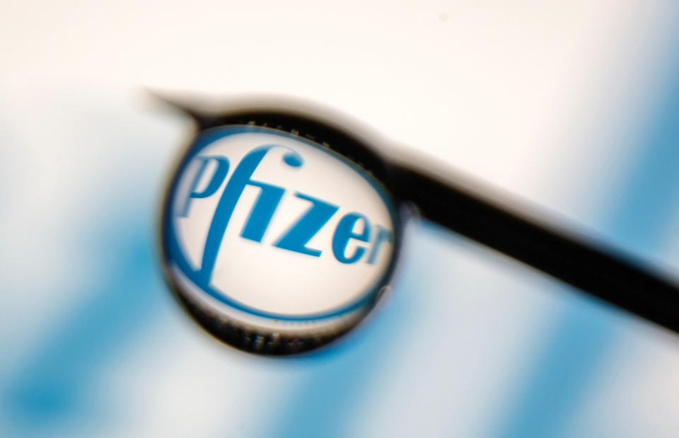 Pfizer logo is reflected in a drop on a syringe needle in this illustration photo taken March 16, 2021. Picture taken March 16, 2021. REUTERS/Dado Ruvic/Illustration