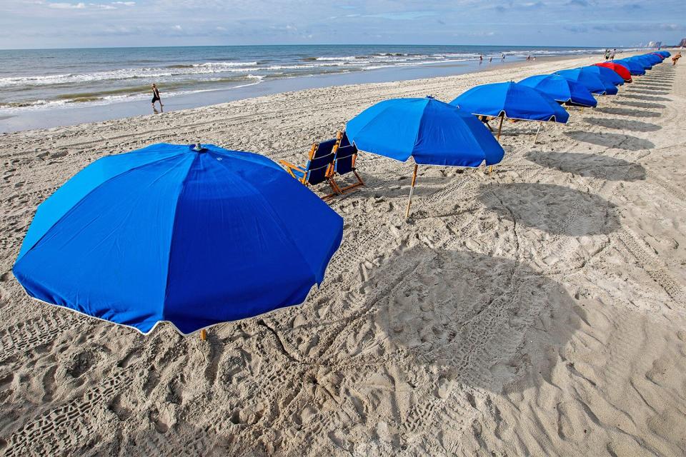 Mandatory Credit: Photo by Mic Smith/AP/Shutterstock (10733860e) Socially distanced umbrellas offer shade across Myrtle Beach, S.C.'s, 60 miles of coastline, where daily COVID-19 cases in Horry County have continued to decrease since mask ordinances were implemented in early July Visitors Enjoy , S.C.'s Wide Open Spaces, Myrtle Beach, United States - 30 Jul 2020