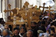 Christian worshippers hold crosses as they walk in a procession along the Via Dolorosa on Good Friday during Holy Week in Jerusalem's Old City April 18, 2014. Christian worshippers on Friday retraced the route Jesus took along Via Dolorosa to his crucifixion in the Church of the Holy Sepulchre. Holy Week is celebrated in many Christian traditions during the week before Easter.