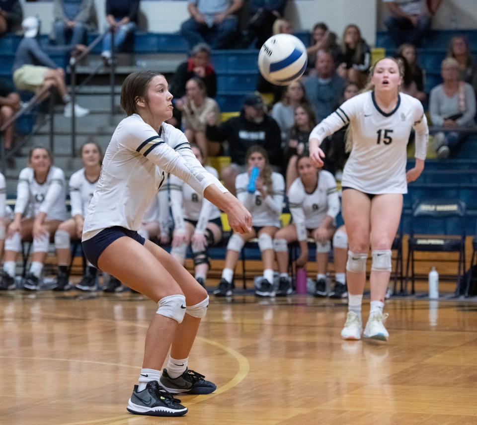 Gulf Breeze High School's Camryn Brooks (No. 1) digs a Navarre high serve during Wednesday's Region 1-6A quarterfinals match against Navarre High School. The dolphins sweep the raiders in three straight 25-20, 25-18, 25-16.