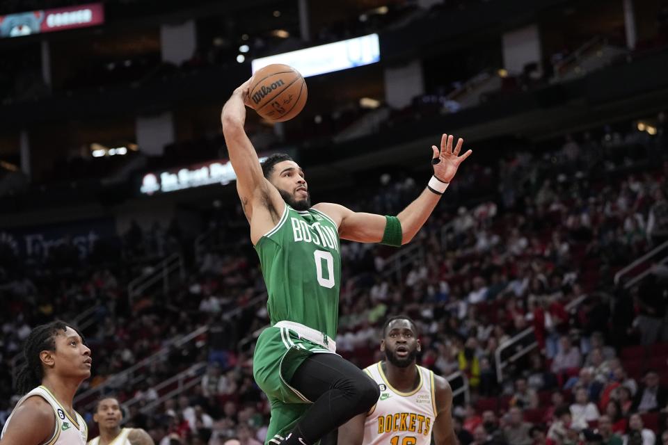 Boston Celtics' Jayson Tatum (0) goes up to attempt a dunk against the Houston Rockets during the first half of an NBA basketball game Monday, March 13, 2023, in Houston. (AP Photo/David J. Phillip)