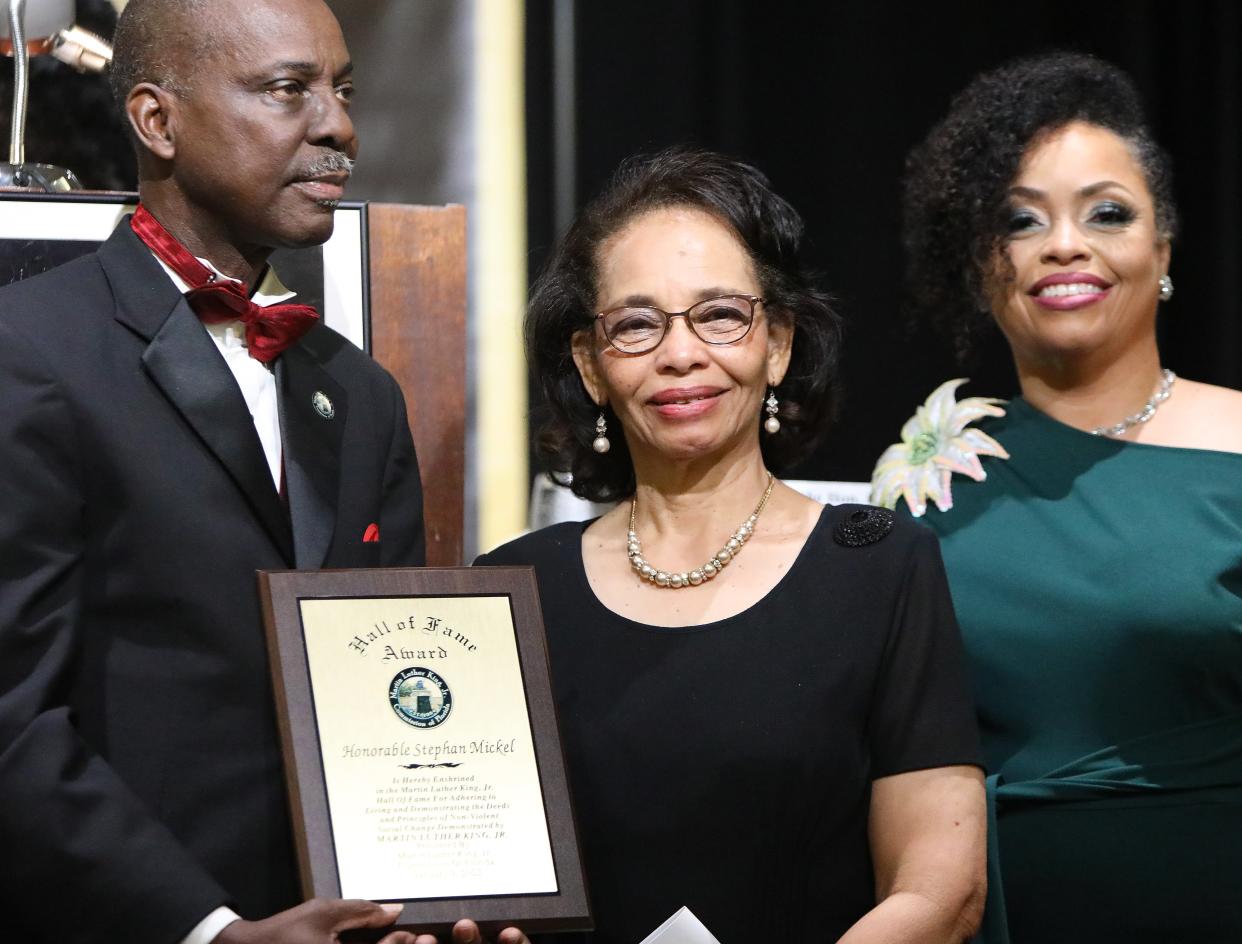 Evelyn Mickle, center, the wife of the late Judge Stephan Mickle, smiles as she and her family receive the 2022 Hall of Fame Award from Rodney Long, left, the founder and president of the MLK Commission of Florida, for her husband during the 37th Annual Martin Luther King, Jr. Hall of Fame Award Banquet, at the Best Western Gateway Grand in Gainesville on Jan. 9.