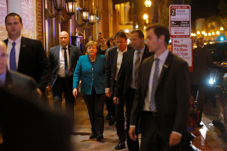 German Chancellor Angela Merkel walks back to her hotel after going out for a walk and dinner shortly after arriving in Washington, U.S., April 26, 2018. REUTERS/Brian Snyder