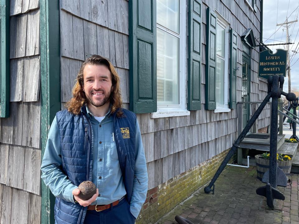 Lewes Historical Society Director Andrew Lyter holds the cannonball found on a nearby sidewalk after it went missing Feb. 17, 2023.