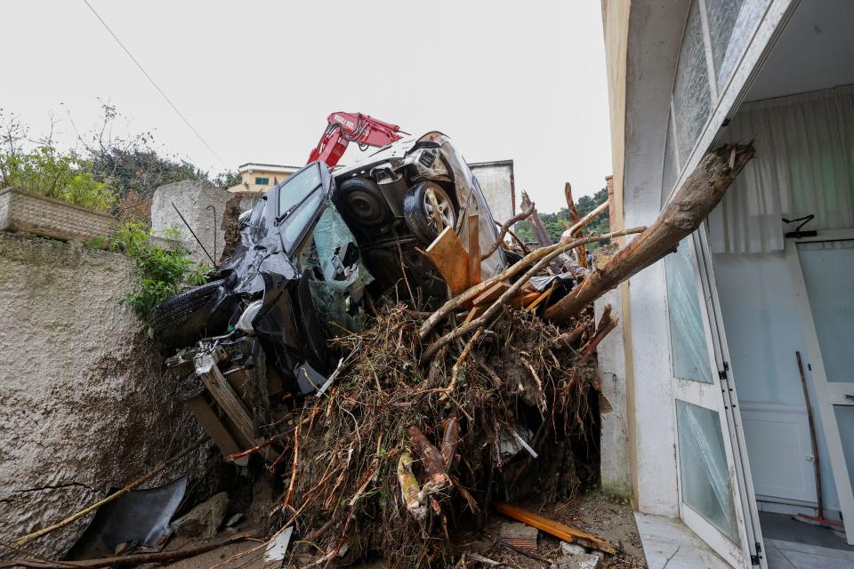 Damaged cars and debris block an alley following a landslide on the Italian holiday island of Ischia, Italy November 26, 2022.