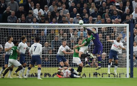 Hugo Lloris of Tottenham Hotspur punches away from Lewis Dunk of Brighton and Hove Albion during the Premier League match between Tottenham Hotspur and Brighton & Hove Albion at Tottenham Hotspur Stadium on April 23, 2019 in London, United Kingdom - Credit: Getty Images