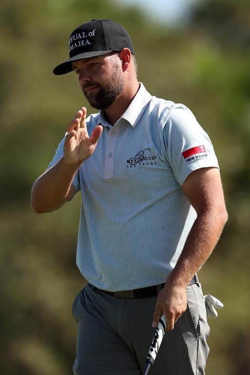 Ryan Moore of the US waves after putting on the 12th hole during the first round of the World Golf Championships-Cadillac Championship, at Trump National Doral Blue Monster Course in Florida, on March 5, 2015