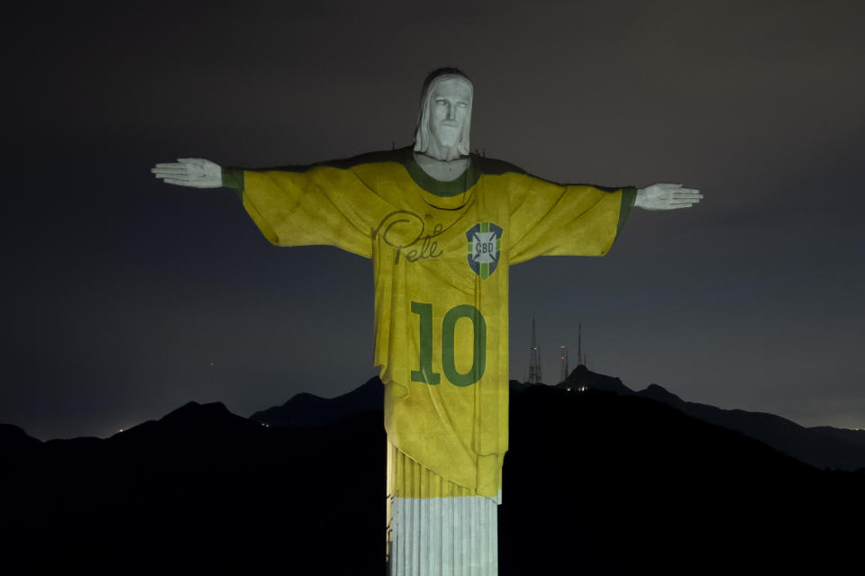 The Christ the Redeemer statue is illuminated with an image of Pele's Brazilian jersey, as a tribute to the soccer legend on his one-year death anniversary, in Rio de Janeiro, Brazil, Friday, Dec. 29, 2023. (AP Photo/Bruna Prado)