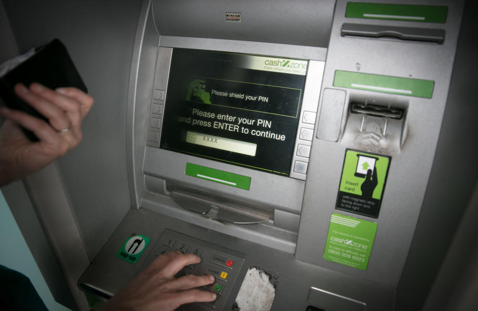 BRISTOL, ENGLAND - NOVEMBER 03:  In this photo illustration a woman uses a cashpoint ATM on November 3, 2017 in Bristol, England. The Bank of England raised interest rates from a historic low for the first time in ten years this week raising costs of lending and concerns for householder debt.  (Photo by Matt Cardy/Getty Images)