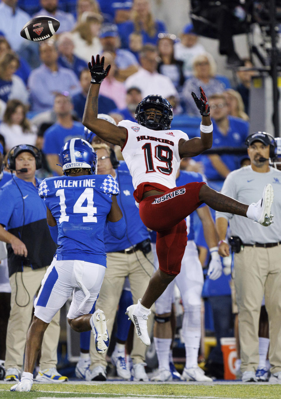 Northern Illinois wide receiver Shemar Thornton (19) reaches out and misses a pass while being guarded by Kentucky defensive back Carrington Valentine (14) during the first half of an NCAA college football game in Lexington, Ky., Saturday, Sept. 24, 2022. (AP Photo/Michael Clubb)