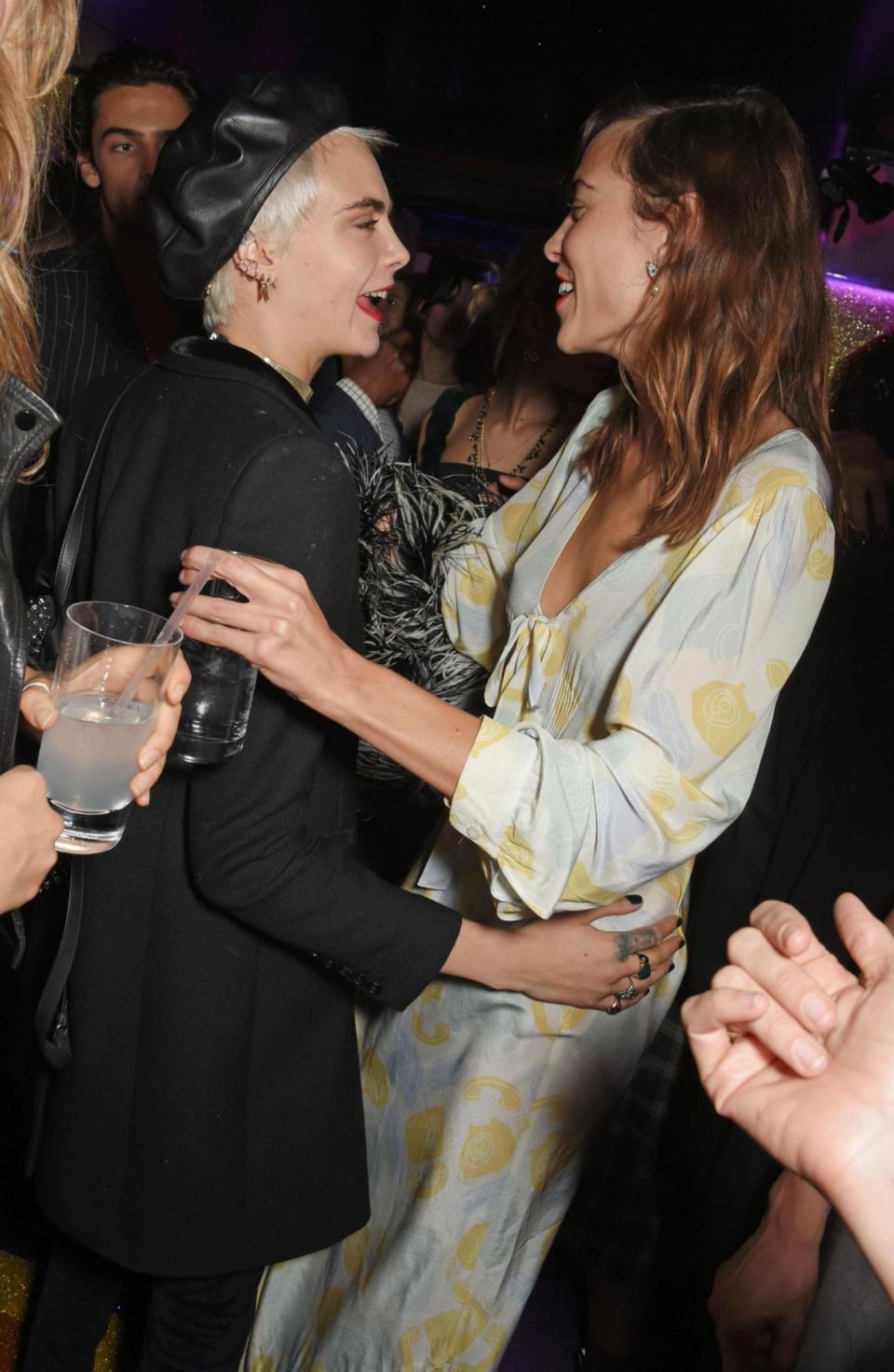 Fashion favourites: Cara Delevingne runs into Alexa Chung (Dave Benett)