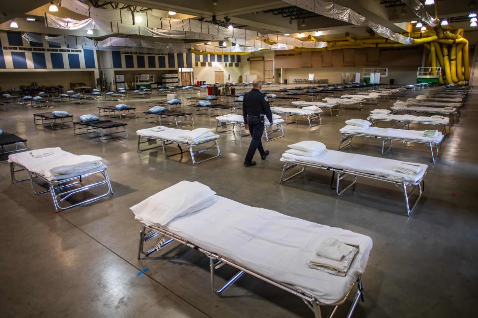 In this file photo taken on March 29, 2020, a temporary hospital is set up by members of the California National Guard in Indio, California. Convention centers, sports arenas, and parking lots across the U.S. are being converted into field hospitals as authorities prepare for a surge in seriously ill coronavirus patients.