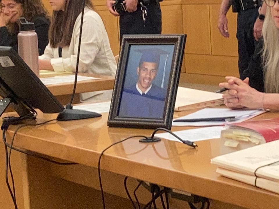 A graduation photo of murder victim Jabree West on the prosecution table in Westchester County Court during sentencing of his killer Eric Williams on Aug. 11, 2023.