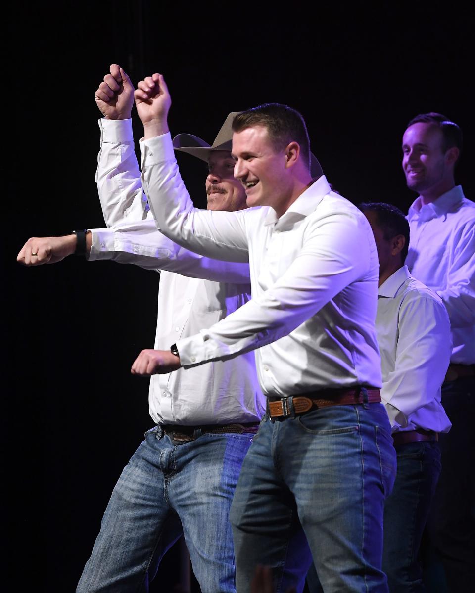 Members of the “Sole Men," volunteers serving the crowd, nearly all of which were women, perform briefly on stage during Wine, Women & Shoes Thursday.