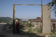 Anahit Aleqyan stands next to the new Armenian-Azerbaijani border in Shurnkh village, about 200 km. (125 miles) south-east of Yerevan, Armenia, Tuesday, June 15, 2021. Shurnukh village, about 200 km. (125 miles) south east of Yerevan, Armenia, Tuesday, June 15, 2021. Anahit Aleqyan, a 65-year-old from the village of Shurnkh in southern Armenia, says that her village was cut in two by a newly defined border with Azerbaijan, and she lost her house in the peace deal. "Every day I come here to gather thyme, look at (my house) and cry," she lamented. (AP Photo/Areg Balayan)