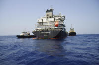 The Panama-flagged, Japanese owned oil tanker Kokuka Courageous, that the U.S. Navy says was damaged by a limpet mine, is anchored off Fujairah, United Arab Emirates, during a trip organized by the Navy for journalists, Wednesday, June 19, 2019. The limpet mines used to attack the oil tanker near the Strait of Hormuz bore "a striking resemblance" to similar mines displayed by Iran, a U.S. Navy explosives expert said Wednesday. Iran has denied being involved. (AP Photo/Fay Abuelgasim)