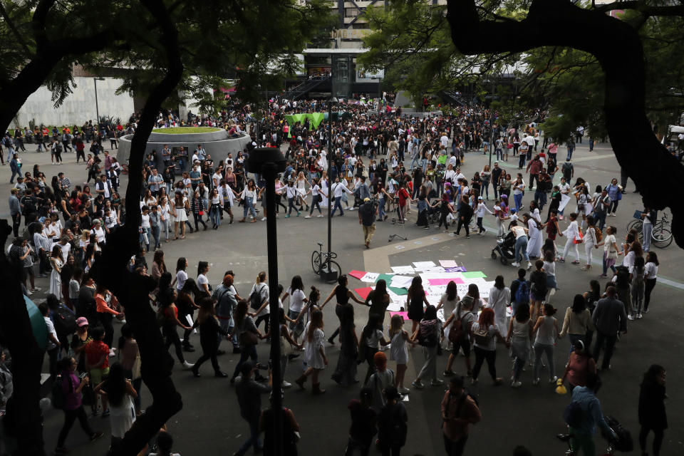 Women stand in a circle during a protest demanding justice and for their safety, sparked by two recent alleged rapes by police, in Mexico City, Friday, Aug. 16, 2019. (AP Photo/Marco Ugarte)